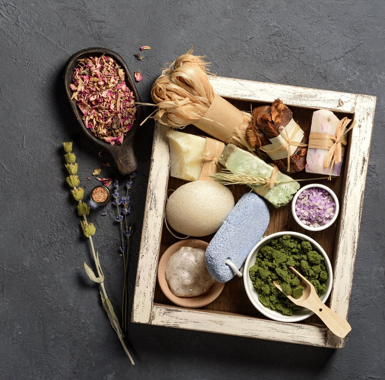 Wooden crate with bath soaps, salts and flowers.